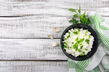 Fotobehang Zuivelproducten Cottage cheese with chives in black ceramic bowl