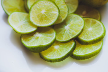 Lime slices background in green