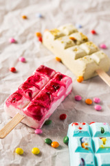 Fototapeta na wymiar Tasty summer popsicles with candies