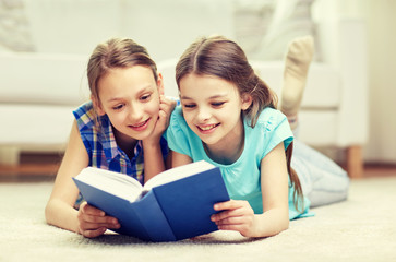 Fototapeta na wymiar two happy girls reading book at home