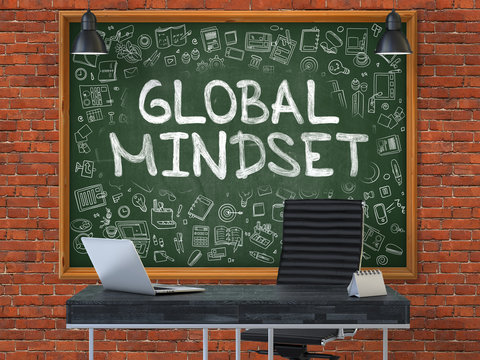 Green Chalkboard With The Text Global Mindset Hangs On The Red Brick Wall In The Interior Of A Modern Office. Illustration With Doodle Style Elements. 3D.