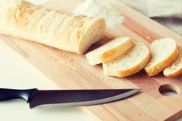 close up of white bread or baguette and knife