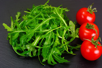 Healthy and diet food: arugula and tomato.