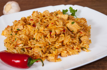 Rice with Vegetables and Meat in a plate on wooden table