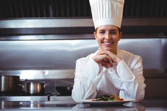 Chef leaning on the counter with a dish