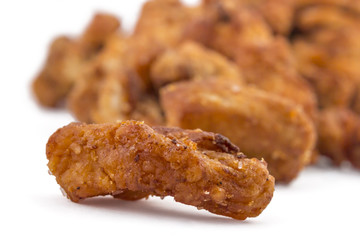 Heap of domestic salty fried pork greaves, cvarci, isolated on white, macro closeup