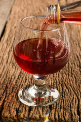 Viewed from the top red wine in a glass timber on the floor vint