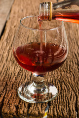 Viewed from the top red wine in a glass timber on the floor vint