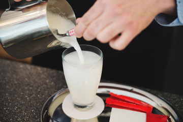 Barista making fresh coffee latte