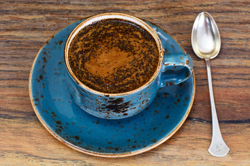 Retro Cup of Coffee on Woody Dark Background