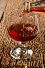 Viewed from the top red wine in a glass timber on the floor vint