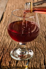 Viewed from the top red wine in a glass timber on the floor vint