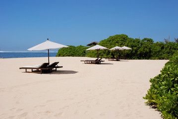 Umbrellas and sunbeds on the beach of Nusa Duo.The Island Of Bali Indonesia 