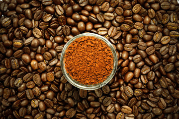 roasted coffee beans and coffee powder in the glass.