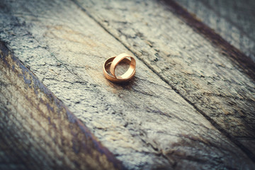 Wedding rings on a wooden background