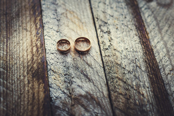 Wedding rings on a wooden background