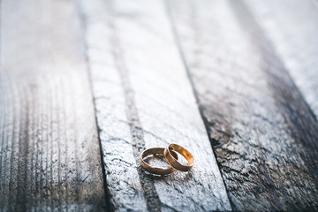 Wedding rings on a wooden background