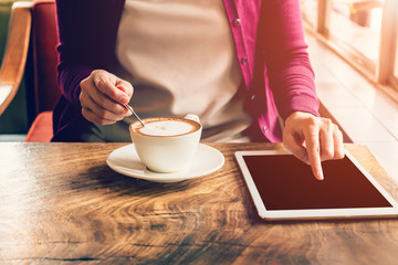 hand woman touchscreen tablet computer and cup in coffee shop