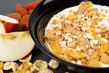 Muesli, nuts, fruits, milk and oatmeal for breakfast.