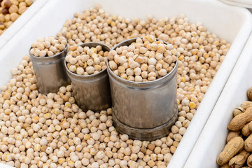 Seller of Peanuts / Close Up of the sales counter of peanuts with small tin cans.
