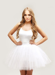 Naklejka premium Beautiful blonde girl wearing white tutu skirt