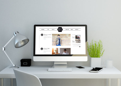 modern clean workspace with fashion celebrity website on screen