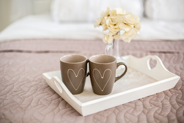 Two cups with painted hearts.