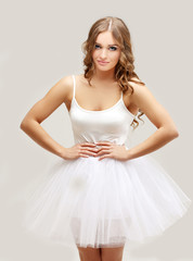 Fototapeta na wymiar Beautiful blonde girl wearing white tutu skirt