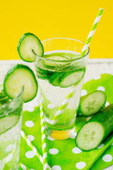 
detox , healthy and refreshing drink ,Nutritious cold sparkling water with fresh green cucumber on a wooden background