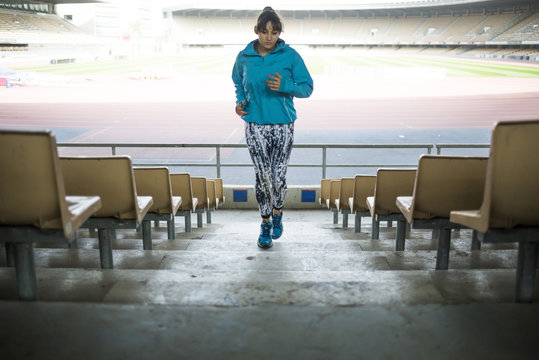 Woman running on a stadium