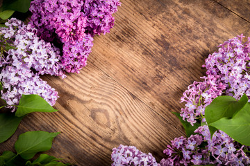 Lilac flowers on brown wood background