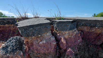 The curb erosion from storms. To indicate the layers of soil and