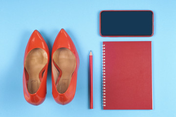 Women clothing set, set of cool stuff and accessories on light blue background. Top view.