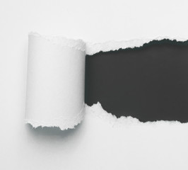 Torn white paper with black space