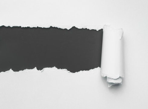 Torn white paper with black space