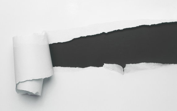 Torn white paper with black space