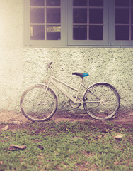 Fototapeta na wymiar Vintage bike against wall,vintage tone style