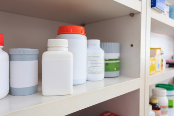 medicine bottles arranged on shelf at drugstore