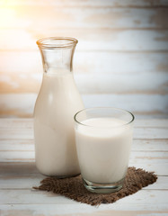 Milk in jar and glass on the old wooden,morning light