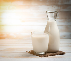 Milk in jar and glass on the old wooden,morning light