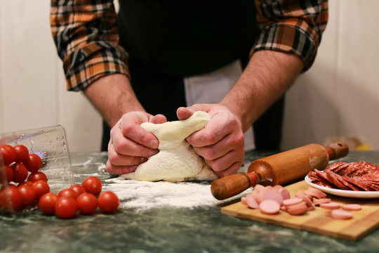 man hand prepare pizza dough topping