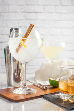 Closeup of a gin and tonic, whiskey and margarita