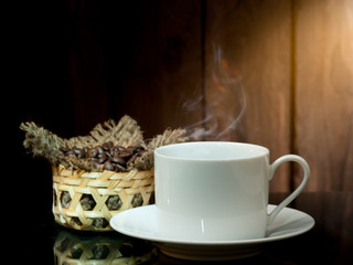 Yellow coffee cup and coffee beans on old wooden background.