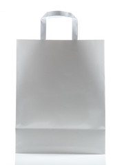 White paper bag with handles on gray background