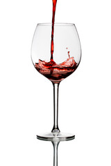 red wine pouring into wine glass isolated on a white background