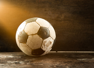 Old Soccer football on old vintage wood table,morning light
