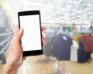 hand holding mobile smart phone touch screen in clothing store