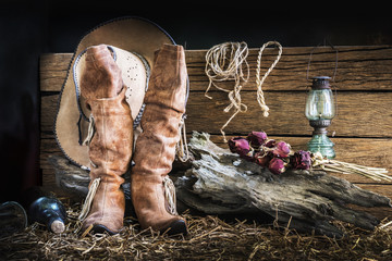Still life with cowboy hat and traditional leather boots