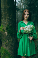 girl in green dres with flowers