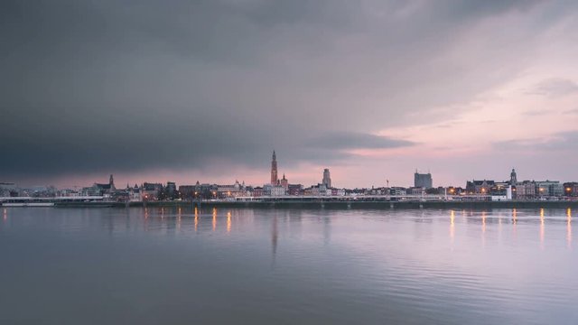 timelapse of antwerp city skyline at sunset from day to night